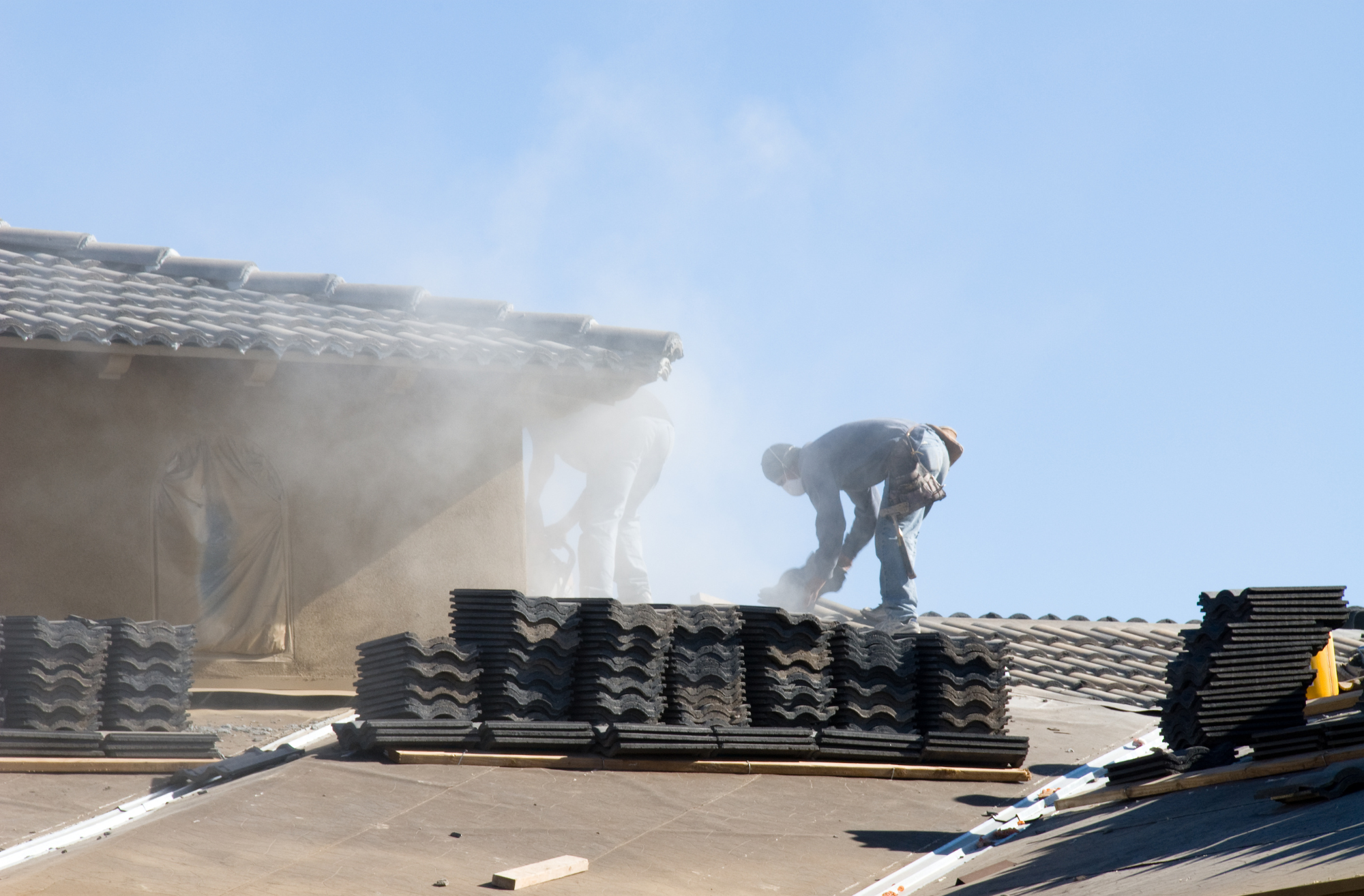 Tear-off: We remove existing roofing materials and inspect the decking underneath. - Systematic removal of old materials, organized disposal.