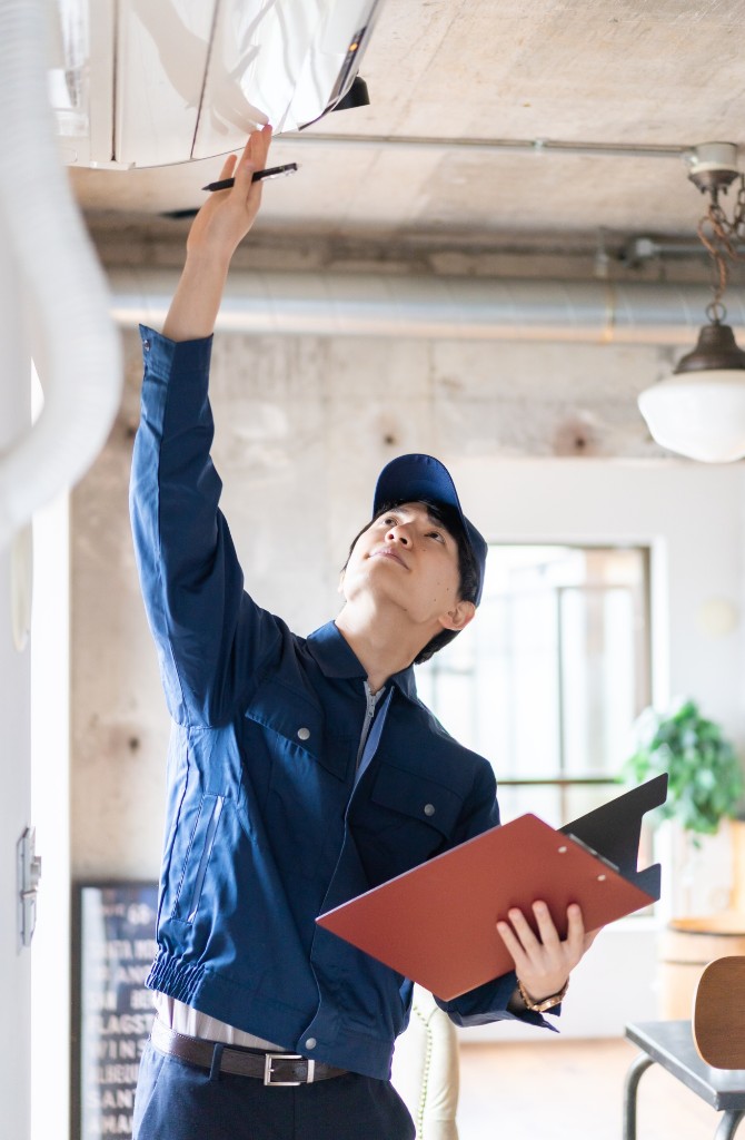 HVAC technician inspecting system